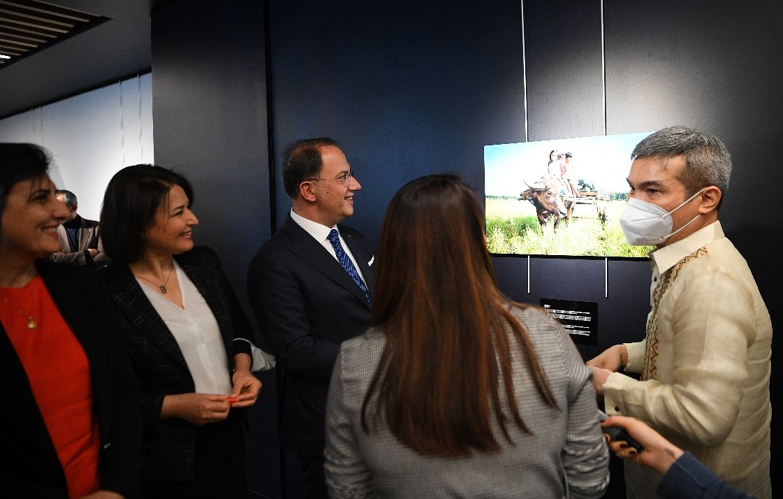 Consul General de Leon explaining the photographs to Mayor Calik and other guests 